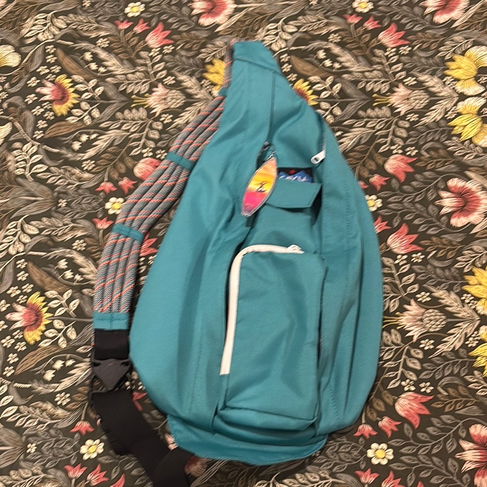 Teal Sling Backpack with White Accents